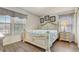 Bedroom features a decorative bed frame, two windows and a wooden floor at 2186 Tripoli Ct, Kissimmee, FL 34747