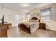 A bedroom with dark wooden furniture and neutral tones with a doorway leading to the bathroom at 2186 Tripoli Ct, Kissimmee, FL 34747