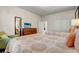 Comfortable bedroom features a large mirror, TV, cozy chair, and two beds with patterned spreads at 2186 Tripoli Ct, Kissimmee, FL 34747
