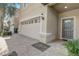 Close-up exterior showcasing the two-car garage, paved driveway, and a well-maintained front entrance with a decorative door at 2186 Tripoli Ct, Kissimmee, FL 34747