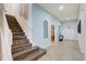 Welcoming foyer with staircase, tile flooring, and neutral paint, offering a glimpse into the home's layout at 2186 Tripoli Ct, Kissimmee, FL 34747