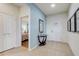 Inviting foyer with neutral tile flooring, a decorative table, and view of a bedroom, creating a warm and welcoming entrance at 2186 Tripoli Ct, Kissimmee, FL 34747