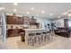 Stylish kitchen with dark cabinetry, stainless steel appliances, and a granite-topped island with seating overlooking the living area at 2186 Tripoli Ct, Kissimmee, FL 34747