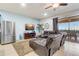 Inviting living room featuring a large leather sectional sofa and sliding glass doors leading to an outdoor patio at 2186 Tripoli Ct, Kissimmee, FL 34747