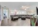 Expansive living room featuring a plush leather sofa, modern decor, and seamless flow into adjacent spaces at 2186 Tripoli Ct, Kissimmee, FL 34747
