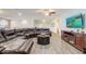 Large living room with a comfortable leather sectional, entertainment center, and open layout, perfect for gatherings at 2186 Tripoli Ct, Kissimmee, FL 34747