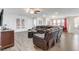 Spacious living room with a comfortable leather sectional, stylish furniture, and bright, natural light at 2186 Tripoli Ct, Kissimmee, FL 34747