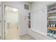 Mud room featuring a door to the laundry room, built-in shelving and a bench with hooks at 2186 Tripoli Ct, Kissimmee, FL 34747