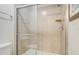 Walk in shower with glass doors, tiled surround and a built-in seat at 2186 Tripoli Ct, Kissimmee, FL 34747