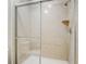 Shower featuring glass sliding door and tiled walls at 2186 Tripoli Ct, Kissimmee, FL 34747