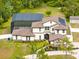 Aerial view of a luxury home with a screened pool, solar panels, and a spacious yard at 2245 Bronco Dr., St Cloud, FL 34771