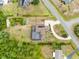 Expansive aerial view of this property showcases a backyard pool, solar panels, and a long driveway at 2245 Bronco Dr., St Cloud, FL 34771