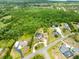Aerial view of a neighborhood with a large property and lots of trees at 2245 Bronco Dr., St Cloud, FL 34771