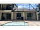 A beautiful view of the backyard with a pool and covered patio, perfect for outdoor relaxation at 2245 Bronco Dr., St Cloud, FL 34771