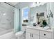 Bright bathroom featuring shower with marble tiling, sleek fixtures, and light blue walls at 2245 Bronco Dr., St Cloud, FL 34771