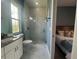 Bathroom with a modern glass-door shower, granite-topped vanity, and marble-look tile at 2245 Bronco Dr., St Cloud, FL 34771