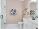 Bright bathroom with marble shower, white vanity with modern fixtures, and decorative shelving at 2245 Bronco Dr., St Cloud, FL 34771