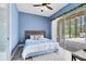 Cozy bedroom with a queen-sized bed, light blue walls, and an outdoor patio at 2245 Bronco Dr., St Cloud, FL 34771