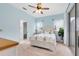 Light and airy bedroom with light blue walls, queen bed, and sliding glass doors at 2245 Bronco Dr., St Cloud, FL 34771