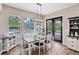 Comfortable dining area with a rustic table, natural light, and views of the backyard pool at 2245 Bronco Dr., St Cloud, FL 34771