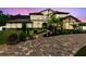 Elegant home featuring a stone facade, manicured landscaping, and a beautifully paved walkway at dusk at 2245 Bronco Dr., St Cloud, FL 34771
