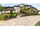 Stunning two-story home with stone accents, lush landscaping, and a brick paver driveway at 2245 Bronco Dr., St Cloud, FL 34771