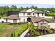 Beautiful two-story home featuring manicured landscaping, stone accents, and a screened-in pool at 2245 Bronco Dr., St Cloud, FL 34771