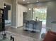 Modern kitchen with island, bar stools, and access to a pool patio through sliding doors at 2245 Bronco Dr., St Cloud, FL 34771