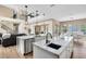 Open-concept kitchen features dual islands, modern lighting, and seamless flow to the dining and living areas at 2245 Bronco Dr., St Cloud, FL 34771