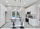 Modern kitchen with an island and pendant lights, view to the pool outside at 2245 Bronco Dr., St Cloud, FL 34771