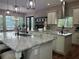 A large kitchen with marble countertops, stainless steel appliances, and an adjacent breakfast nook overlooking the pool at 2245 Bronco Dr., St Cloud, FL 34771
