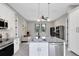 Open concept kitchen with island featuring a stainless steel sink and modern finishes at 2245 Bronco Dr., St Cloud, FL 34771