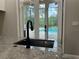 A close-up of the kitchen sink with a view to the screened-in pool area at 2245 Bronco Dr., St Cloud, FL 34771