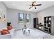 Spacious living room featuring a ceiling fan, ample natural light, and stylish decor at 2245 Bronco Dr., St Cloud, FL 34771