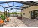 Relaxing screened patio includes comfortable seating and a view of the well-maintained backyard at 2245 Bronco Dr., St Cloud, FL 34771