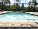 A close view of the in-ground pool with brick surround and waterfall feature in a screened-in enclosure at 2245 Bronco Dr., St Cloud, FL 34771