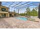 Relaxing screened-in pool area features brick pavers and comfortable lounging options at 2245 Bronco Dr., St Cloud, FL 34771