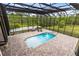 Screened-in pool area features a brick-paved patio with pool and comfortable seating at 2245 Bronco Dr., St Cloud, FL 34771