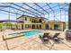 Stunning backyard featuring a screened pool and hot tub, perfect for outdoor entertaining and relaxation at 2245 Bronco Dr., St Cloud, FL 34771