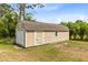 Tan backyard shed with a garage door at 2245 Bronco Dr., St Cloud, FL 34771