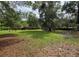 Spacious backyard featuring mature trees, providing a private and peaceful outdoor setting at 245 S Rhodes St, Mount Dora, FL 32757