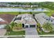 Stunning aerial view of a home, highlighting its prime location with a picturesque lake and well-manicured surroundings at 2586 Lancaster Ridge, Davenport, FL 33837