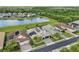 Aerial view of a lovely home showcasing a scenic pond view and a screened-in patio at 2586 Lancaster Ridge, Davenport, FL 33837