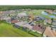 Enjoy this aerial view highlighting the community's golf course, pond, and the home's screened-in patio at 2586 Lancaster Ridge, Davenport, FL 33837