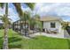 This well manicured backyard features a screened-in patio with a charming outdoor dining space at 2586 Lancaster Ridge, Davenport, FL 33837
