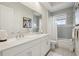 Bathroom featuring double vanity, bathtub, shower and decorative artwork at 2586 Lancaster Ridge, Davenport, FL 33837