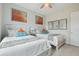 Cozy bedroom featuring two twin beds, and decorative artwork at 2586 Lancaster Ridge, Davenport, FL 33837