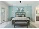 Calm bedroom with a wooden bed frame, decorative wall art, and light blue accent wall at 2586 Lancaster Ridge, Davenport, FL 33837