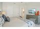 Bedroom featuring a wooden bed frame, ensuite bath, decor and a television mounted on the wall at 2586 Lancaster Ridge, Davenport, FL 33837