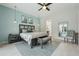 Bright bedroom featuring a light blue wall, ceiling fan, accent chair, and a glimpse of pool view at 2586 Lancaster Ridge, Davenport, FL 33837